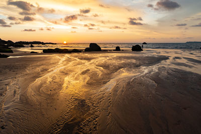 Scenic view of beach against sky during sunset