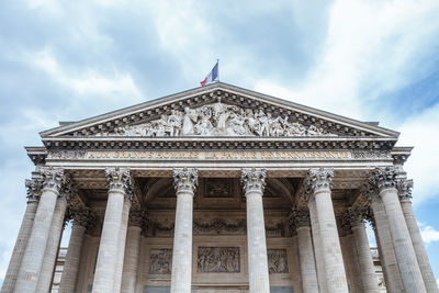 Low angle view of historical building against cloudy sky