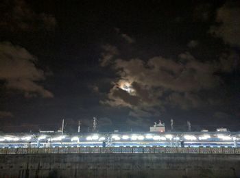 Illuminated building against sky at night