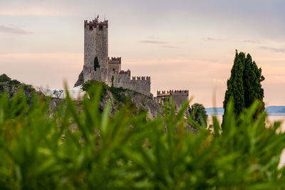 Low angle view of fort against sky during sunset