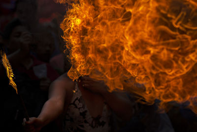 High angle view of fire-eater blowing flames