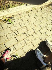 Low section of people walking on footpath