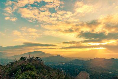 Scenic view of mountains against sky at sunset