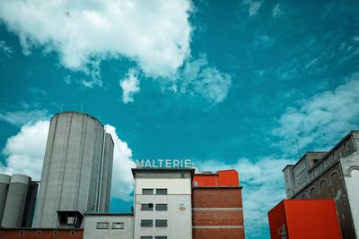 Low angle view of buildings against blue sky