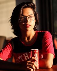 Portrait of a young woman drinking glasses