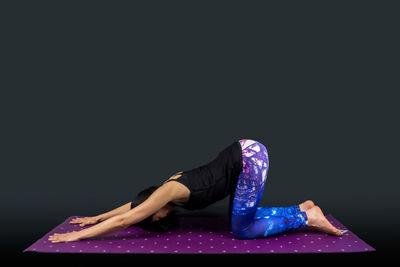 Midsection of woman against black background