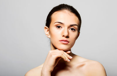 Portrait of a beautiful young woman over white background