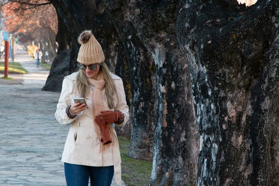 Full length of man using mobile phone