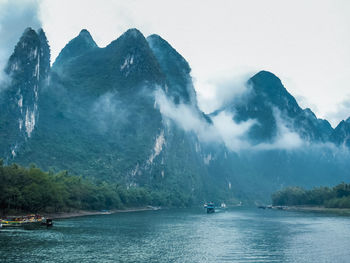 Scenic view of river against mountain