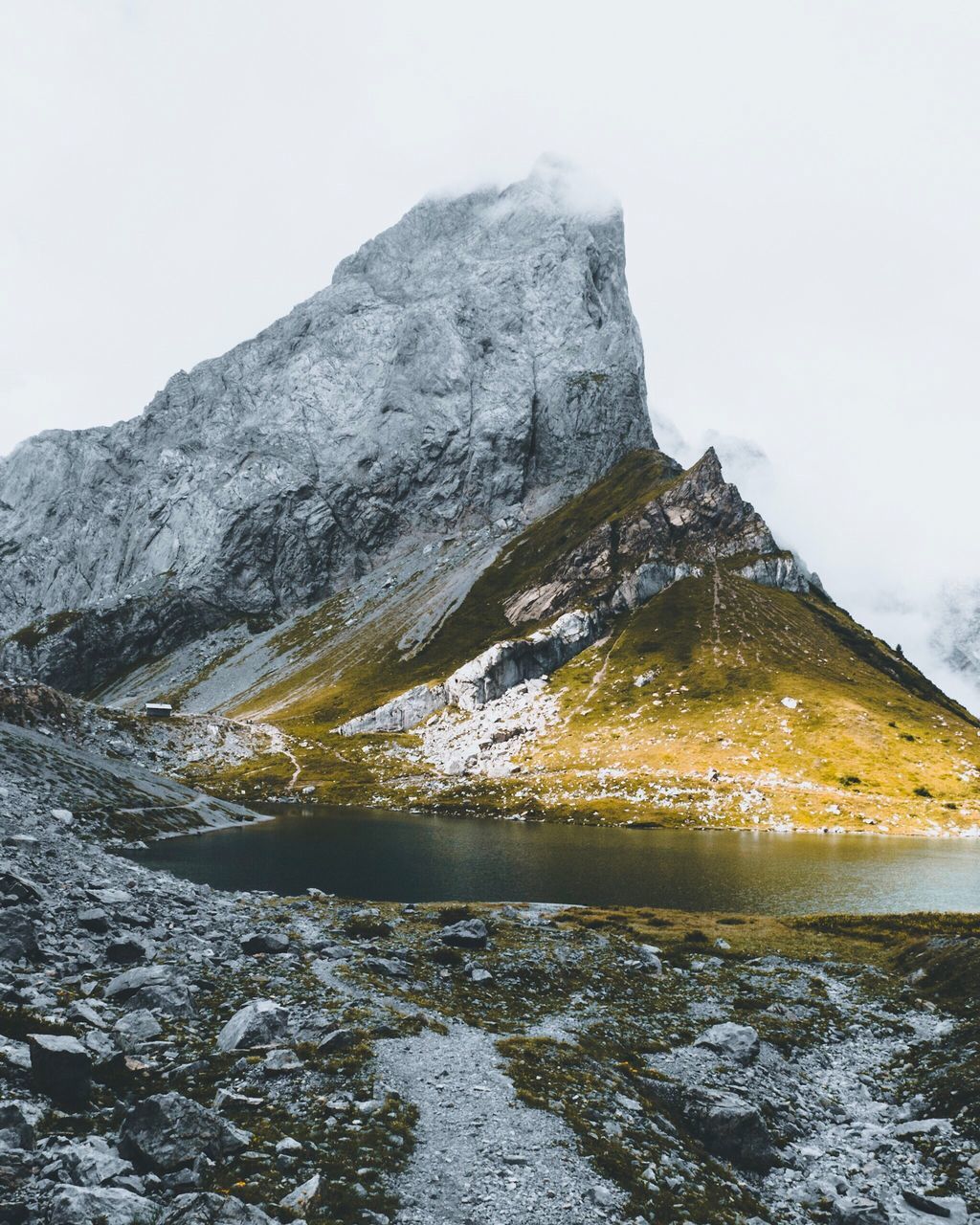 sky, rock, beauty in nature, mountain, scenics - nature, nature, solid, rock - object, water, tranquility, tranquil scene, no people, cold temperature, winter, non-urban scene, snow, day, mountain range, formation, mountain peak, flowing water