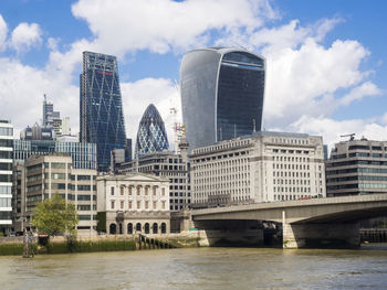 View of cityscape against cloudy sky