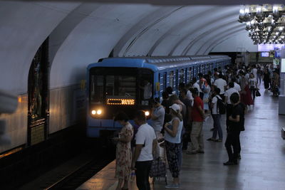 People waiting at railroad station platform