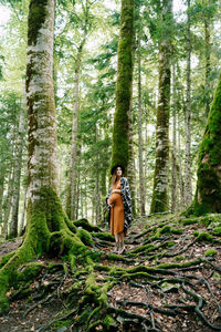 Woman standing in forest