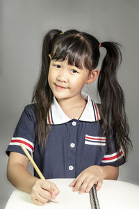 Portrait of a smiling girl holding face