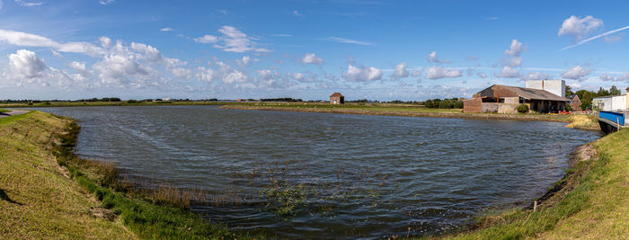 Panoramic view of sea and buildings against sky