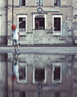 Woman standing in front of building