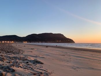 Scenic view of beach against sky during sunset