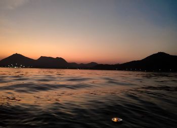 Scenic view of sea against orange sky