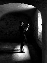 Full length of man standing in tunnel