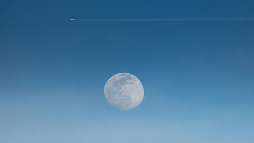 Low angle view of vapor trail against clear blue sky