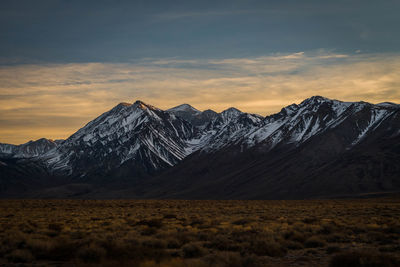 Scenic view of snowcapped mountains against sky during sunset