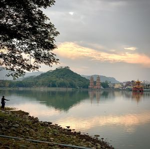 Scenic view of lake against sky at sunset