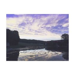 Scenic view of landscape against cloudy sky