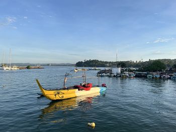 Boats in sea against sky