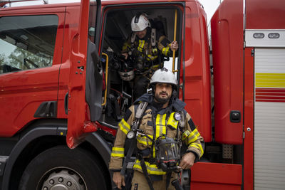 Firefighter in front of fire engine