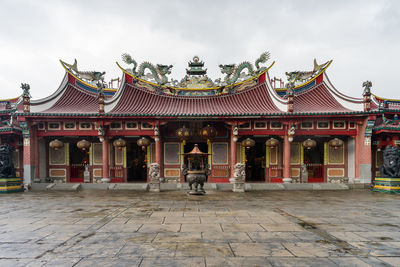 Rear view of man walking on historic building against sky