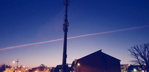 Low angle view of illuminated building against sky at dusk