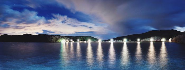 Panoramic shot of reservoir against cloudy sky at night