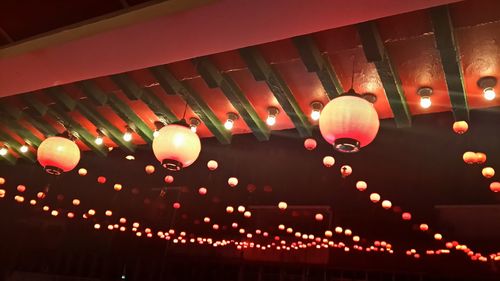 Low angle view of lanterns hanging at night