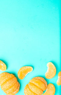 Close-up of fruits on table against blue background