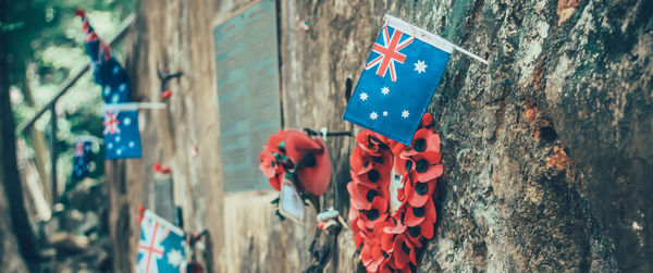 Close-up of flags hanging against wall