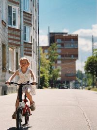 Side view of man riding bicycle on street