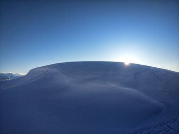 Snowcapped mountains against clear blue sky