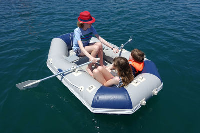 Three children having fun in an inflatable dinghy