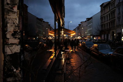 People walking on street in city at night