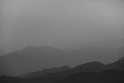 Scenic view of silhouette mountains against sky