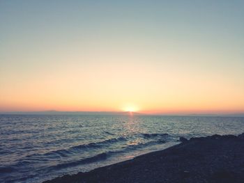 Scenic view of sea against clear sky during sunset