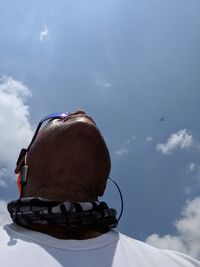 Man flying kite against sky