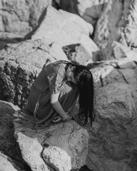 Woman sitting on rock