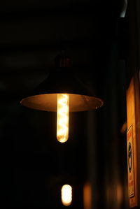 Close-up of illuminated pendant lights hanging from ceiling