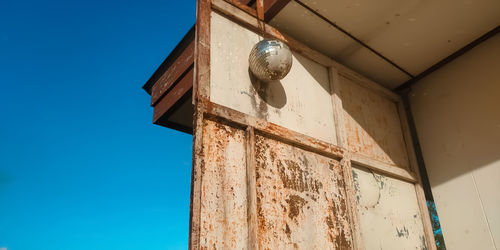 Low angle view of old building against clear blue sky