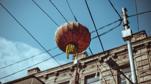 Low angle view of lanterns hanging against sky