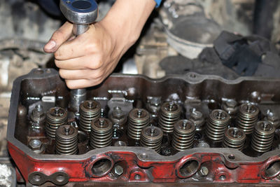 The mechanic is checking the engine.