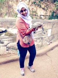 Full length portrait of woman standing outdoors