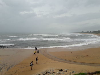 Man standing on beach against sky