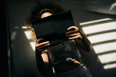 Midsection of woman holding book